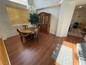 Charming dining area with hardwood floors, stylish lighting, and ample space for entertaining at 6351 Davidson Ct, Las Vegas, NV 89110