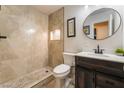 Modern bathroom with a walk-in shower with tile surround, and sleek vanity with dark wood cabinets at 6608 Burgundy Way, Las Vegas, NV 89107