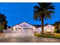 Beautiful single-story home featuring a three-car garage and meticulously landscaped front yard at 7670 Descanso Ln, Las Vegas, NV 89123
