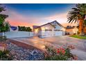 Spacious home with RV parking, featuring a three-car garage, and a beautiful desert landscape at 7670 Descanso Ln, Las Vegas, NV 89123