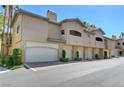 Charming condo building with multiple attached garages and desert landscaping at 8717 Red Brook Dr # 201, Las Vegas, NV 89128