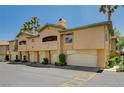 A townhome complex with private garages, neutral paint, and well manicured landscaping at 8717 Red Brook Dr # 201, Las Vegas, NV 89128