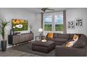 Cozy living room with a comfortable sectional couch and stylish decor at 899 Apatite Pl # Lot 61, Henderson, NV 89011