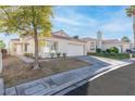Charming single-story home featuring a two-car garage and desert landscaping at 9741 Horizon Hills Dr, Las Vegas, NV 89117