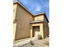 Side view of a two-story home featuring a neutral stucco exterior at 9844 Ashton Pines Ct, Las Vegas, NV 89147