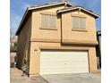 Two-story home featuring a two-car garage and neutral stucco exterior with a gas meter at 9844 Ashton Pines Ct, Las Vegas, NV 89147