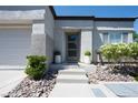 Inviting front entrance with landscaped walkway and stylish front door with glass panels at 10532 Redwood Ash Ave, Las Vegas, NV 89144