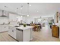 Bright, modern kitchen with white cabinets, stainless steel appliances, and an open floor plan at 129 Barton Bay Ave, North Las Vegas, NV 89031