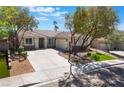Attractive one-story home featuring a three car garage, low maintenance landscaping, and a circular driveway at 1387 Minuet St, Henderson, NV 89052