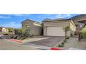 Inviting single-story home with a two-car garage, neutral color palette, and desert landscaping at 161 Cabo Cruces Dr, Henderson, NV 89011