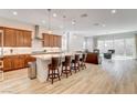 Open-concept kitchen featuring an island with bar seating and stainless steel appliances next to a living space at 161 Cabo Cruces Dr, Henderson, NV 89011