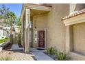 A covered front entrance has a security door and a desert-themed garden with drought-resistant plants at 1833 Winners Cup Dr, Las Vegas, NV 89117