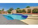 Sparkling backyard pool and spa surrounded by lush landscaping and a privacy wall at 2150 Ponticello Dr, Henderson, NV 89052