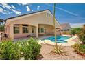 Beautiful backyard featuring a private pool and spa, covered patio, and desert landscaping at 2150 Ponticello Dr, Henderson, NV 89052