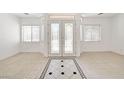 Elegant entryway featuring tile flooring and decorative glass double doors at 2150 Ponticello Dr, Henderson, NV 89052