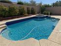 Sparkling blue pool and spa surrounded by a well-maintained backyard, perfect for relaxation and outdoor enjoyment at 2150 Ponticello Dr, Henderson, NV 89052