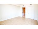 Bright, open bedroom with neutral tile floors and a view into a bathroom at 222 Karen Ave # 2506, Las Vegas, NV 89109