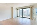 Bright bedroom featuring neutral decor, tile floors, and a sliding glass door to a balcony with city views at 222 Karen Ave # 2506, Las Vegas, NV 89109