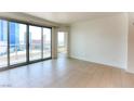 Bright, spacious living room featuring tile flooring, a sliding glass door to the balcony, and neutral decor at 222 Karen Ave # 2506, Las Vegas, NV 89109