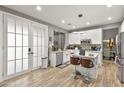 Modern kitchen with white cabinets, stainless steel appliances, and a breakfast bar with seating at 2250 Tedesca Dr, Henderson, NV 89052