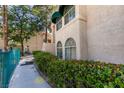 Exterior view of condo building with stucco walls, awning covered windows, and desert plants at 2251 Wigwam Pkwy # 824, Henderson, NV 89074