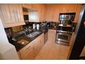 Modern kitchen boasting stainless steel appliances, granite countertops, and ample cabinet space at 230 E Flamingo Rd # 129, Las Vegas, NV 89169