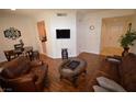 Open living room showcasing hardwood floors, a comfortable seating arrangement, and elegant decor at 230 E Flamingo Rd # 129, Las Vegas, NV 89169