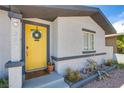 Close up of the front entrance showcasing the yellow door and decorative wreath at 237 Cervantes St, Las Vegas, NV 89101