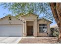 Attractive home with a covered entryway, two-car garage, and desert landscaping at 2410 Morocco Ave, North Las Vegas, NV 89031