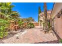 Charming courtyard with a fountain and lush landscaping, creating a private oasis at 27 Via Paradiso St, Henderson, NV 89011