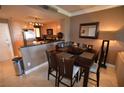 Cozy dining area with modern table, seating for six, and adjacent kitchen at 270 E Flamingo Rd # 319, Las Vegas, NV 89169