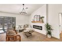 Cozy living room with modern fireplace, light wood floors, and ample natural light at 3009 Anna Bay Dr, Las Vegas, NV 89134
