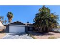 Inviting single-story home with an attached garage and mature landscaping, ready for move-in at 3020 Wilmington Way, Las Vegas, NV 89102