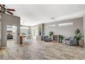 Open-concept living room with wood-look floors, fireplace, and views of the kitchen at 3112 Haddon Dr, Las Vegas, NV 89134