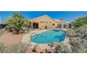 Backyard pool with spa featuring desert landscaping, privacy fencing, and a lounge area for relaxing outdoors at 3112 Haddon Dr, Las Vegas, NV 89134