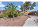View of a single-story house with a terracotta roof, desert landscaping, and an attached two-car garage at 3158 La Luna Cir, Henderson, NV 89014