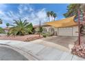 Eye-level view of a single-story house with a terracotta roof, desert landscaping, and an attached garage at 3158 La Luna Cir, Henderson, NV 89014
