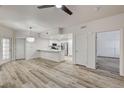 Open concept living space with wood flooring and adjacent kitchen with breakfast bar at 3400 Cabana Dr # 1048, Las Vegas, NV 89122