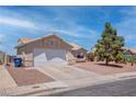Single-story home with low maintenance desert landscaping and a two-car garage at 394 Lombardy Cir, Henderson, NV 89015