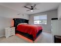 Modern primary bedroom with a unique headboard, ambient lighting, and large window at 394 Lombardy Cir, Henderson, NV 89015