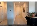 Bright hallway with tile floors leads to rooms and the front door of the home at 411 Hellebores Ave, North Las Vegas, NV 89084