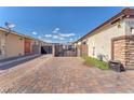Paver driveway with a private gate offering extra parking and security, enhancing the home's curb appeal at 4510 Rubious Ave, North Las Vegas, NV 89084