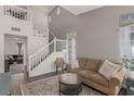 Spacious living room with a cozy sofa, staircase, and neutral color palette at 4622 English Lavender Ave, North Las Vegas, NV 89031