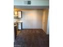 Functional kitchen area featuring essential appliances and ample cabinet space at 5220 Mission Carmel Ln # 207, Las Vegas, NV 89107