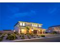 Eye-catching two-story house boasting a spacious three-car garage and beautifully landscaped yard with ambient lighting at 5328 Hickory Tree St, Las Vegas, NV 89149