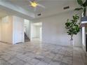 A spacious, light-filled living room featuring tile floors, neutral walls and a fireplace at 5600 Grossmont Ave, Las Vegas, NV 89110