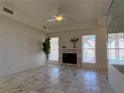 The bright and open living room has tile floors, neutral colors, a fireplace and plentiful light at 5600 Grossmont Ave, Las Vegas, NV 89110