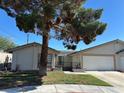 Charming single-story home with desert landscaping and a two-car garage, set under a clear blue sky at 5720 Goldmount Ave, Las Vegas, NV 89107