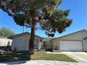 Charming single-story home with desert landscaping and a two-car garage, set under a clear blue sky at 5720 Goldmount Ave, Las Vegas, NV 89107