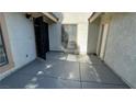 Spacious concrete patio area with a metal gate, offering a private outdoor space at 5720 Goldmount Ave, Las Vegas, NV 89107